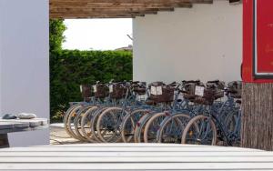 a row of blue bikes parked next to a wall at Camping Les Perouses in Saint-Clément-des-Baleines