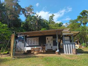 a small house with a table in front of it at Tupi's Beachfront Minihouse in Bacungan