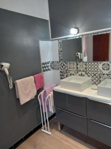 a bathroom with two sinks and a mirror at La Maison de Chouquette in Limoux +19 photos