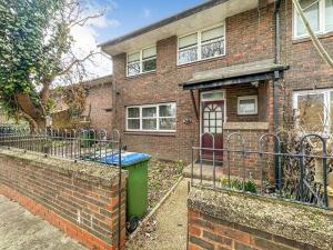 a brick house with a green trash can in front of it at Newly Refurbished 3 Bed House Near London o2 Arena in London