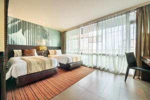 a hotel room with two beds and a large window at M2 de Bangkok Hotel in Bangkok +78 photos