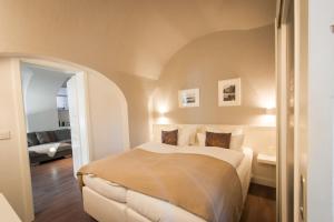 a bedroom with a bed and a living room at Gutshaus Krummin Usedom in Krummin