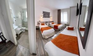 Posteľ alebo postele v izbe v ubytovaní Hotel Bella Dolores