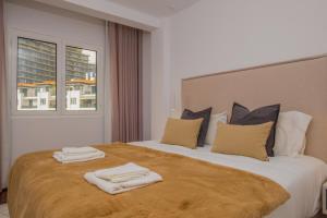 a hotel room with a large bed with towels on it at Recanto da Princesa by Madeira Sun Travel in Funchal