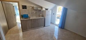 a kitchen with a sink and a refrigerator at F&R VILLA in Neoi Epivates
