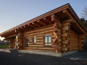 a log cabin with a gambrel roof at Aurora in Bushmills