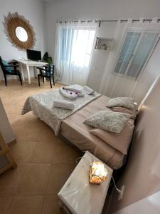 a room with two beds and a table with a candle at B&B Mi Ma Bo, Sal Rei, Boa Vista, Cape Verde, FREE WI-FI in Sal Rei