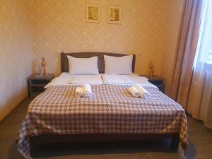 a bedroom with a bed with two towels on it at Apartment Nikolo in Stepantsminda