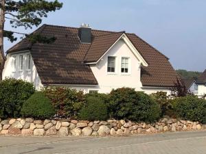a white house with a brown roof at Appartement Louise in Wustrow