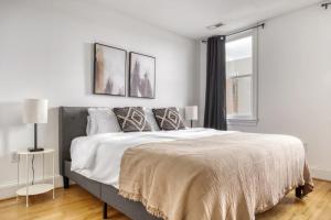 a white bedroom with a large bed and a window at Deluxe Mount Vernon 2BR w WD nr Metro WDC-576 in Washington