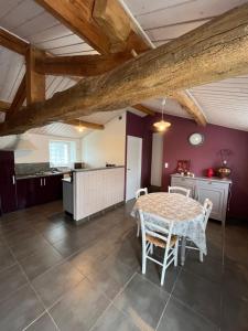 a kitchen and dining room with a table and chairs at Domaine de la moriniere in Commequiers