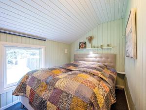- une chambre avec un lit dans une pièce dotée d'une fenêtre dans l'établissement Holiday home Nørre Nebel XVII, à Nørre Nebel