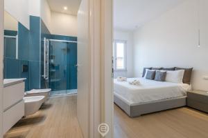 a bedroom with a bed and a bathroom with a tub at Enchanting Panoramic Retreat in Cagliari