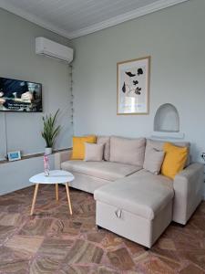 sala de estar con sofá y mesa en Garden Rooms en Pírgos Psilonérou