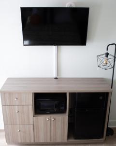 een flatscreen-tv op de top van een houten entertainmentcentrum bij Pine Lodge in Encampment