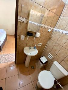 a bathroom with a toilet and a sink at Casa Glamour in Trinidad