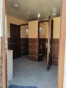 baño con 2 puertas correderas en una habitación en Namla Bedouin Camp en Umm Şawwānah