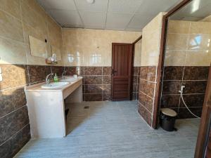 a bathroom with a sink and a shower at Namla Bedouin Camp in Umm Şawwānah