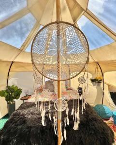 a large chandelier hanging from a tent at The Pisces-a stargazing, luxury glamping tent in Rogersville
