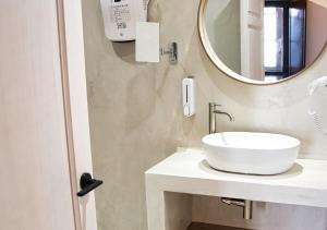 a bathroom with a white sink and a mirror at Casa Rural Casa Levante in Arcos de la Frontera
