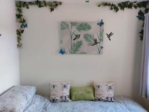 a bedroom with a bed with a picture on the wall at Hot Tub house close to Woodland and Peak District in Brimington