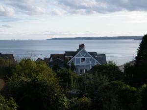 a house on the shore of a body of water at Tudor Court Guest House in Falmouth