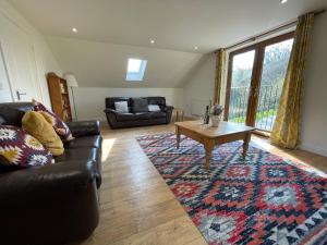 a living room with a couch and a coffee table at High Lodge in Watchet