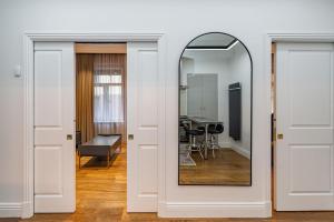 a mirror in a room with a living room at Quality 1 BD Old Town Apartment by Hostlovers in Kaunas