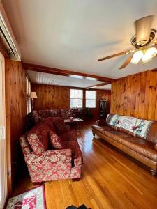 a living room with a couch and a ceiling fan at Home in Newland with River Views in Newland