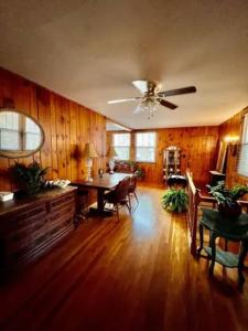 a living room with a table and a ceiling fan at Home in Newland with River Views in Newland