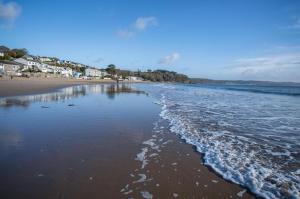 a view of a beach with the tide coming in at Glenvale - 2 Bedroom Apartment - Saundersfoot in Saundersfoot