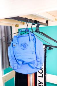 a blue bag is hanging on a shelf at CoLiving - Lockhart Road 388 in Hong Kong