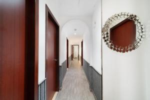 a hallway with a mirror and a long corridor at Elan Rimal Suites JBR Beach Sea View in Dubai