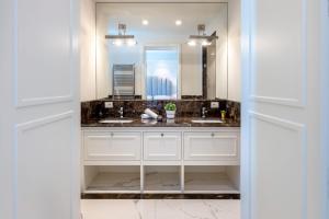 a bathroom with two sinks and a mirror at Genteel Home Villa Prato in Prato +34 photos