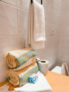 a pile of towels sitting on a table in a bathroom at El Palmar Beach Tennis Resort in San Patricio Melaque