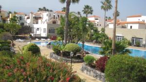 a view of a resort with a swimming pool and palm trees at Las Adelfas 2 in San Miguel de Abona