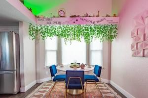a dining room with a table and blue chairs at 2 King Beds / Hot Tub / BBQ / Hiking / Fire Pit in Littleton +29 photos
