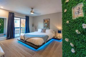 a bedroom with a bed with a green wall at 2 King Beds / Hot Tub / BBQ / Hiking / Fire Pit in Littleton