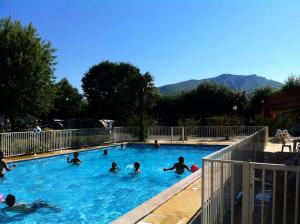 a group of people swimming in a swimming pool at Camping Europ'Camping - Maeva in Ascarat +11 photos