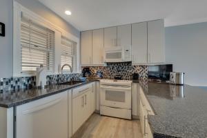 a kitchen with white cabinets and a counter top at 314 Water Street Inn in Boyne City