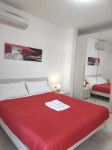 1 dormitorio con cama roja y manta roja en Cla House, en Assemini