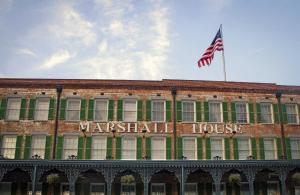 a building with an american flag on top of it at The Marshall House, Historic Inns of Savannah Collection in Savannah