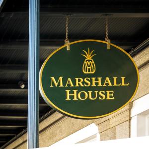 a green and gold sign for a marestation house at The Marshall House, Historic Inns of Savannah Collection in Savannah