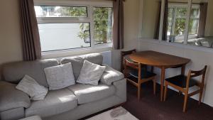 a living room with a couch and a table at Robin hood retreat 2 bedroom chalet Free parking in Nottingham