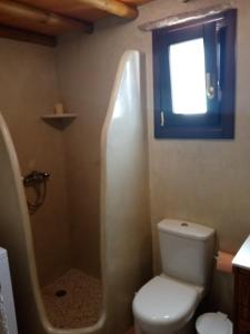 a bathroom with a toilet and a window at Monitsia Traditional House in Khalkíon +23 photos