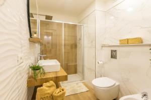 a bathroom with a toilet and a shower and a sink at Mirasole House in Massa Lubrense +27 photos