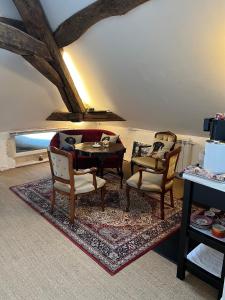 a living room with two chairs and a table at LE PRIEURE DE BUFFON in Buffon