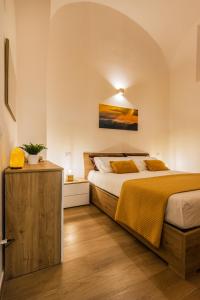 a bedroom with a large bed and a wooden floor at Mirasole House in Massa Lubrense