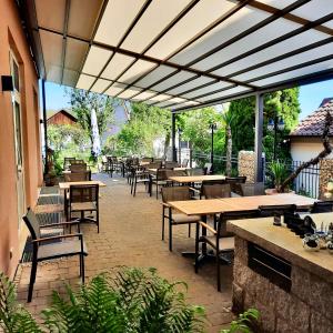 an outdoor patio with tables and chairs and awnings at Gasthof zum Bären in Bühlertann