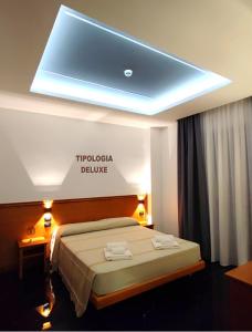 a hotel room with a bed with a led ceiling at Hotel TEA - Praia a Mare in Praia a Mare